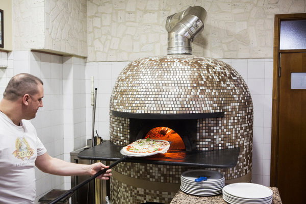 周一，位于意大利圣维塔利亚诺的小马餐厅的Gennaro Marano正在准备披萨。为了减少大气污染，市长安东尼奥·法尔科内发布了一项法令，禁止使用没有配备过滤装置的燃烧木材的炉子。